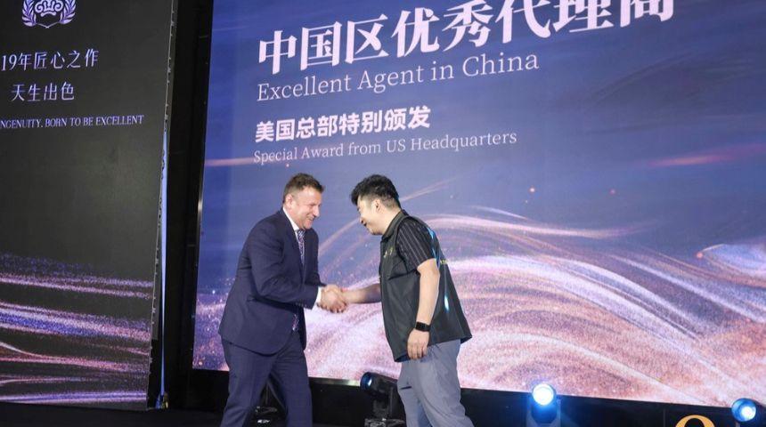 Spencer Nicholls, left, of Kingsdown, presents Mao Jian with the company's Excellent Agent in China award.